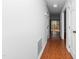 Hallway with wood floors leading to back deck with natural light at 6413 English Oaks Dr, Raleigh, NC 27615