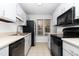 Well-lit kitchen features neutral counters, tile floor, and updated appliances at 6413 English Oaks Dr, Raleigh, NC 27615
