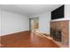 Bright living room featuring hardwood floors and a brick fireplace at 6413 English Oaks Dr, Raleigh, NC 27615