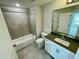 Modern bathroom with gray tile, bathtub, and vanity at 2103 Lambert Rd # 62, Cary, NC 27519