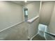 Upstairs hallway with grey carpet and doors to bedrooms at 2103 Lambert Rd # 62, Cary, NC 27519