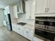 Modern kitchen features white cabinets, stainless steel appliances, and a spacious island at 2103 Lambert Rd # 62, Cary, NC 27519