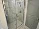 Glass enclosed shower with tile surround and brushed nickel hardware at 235 Grand Griffon Way, Lillington, NC 27546