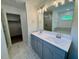 Bathroom features double sink vanity with modern lighting, glass shower and a view to the walk-in closet at 235 Grand Griffon Way, Lillington, NC 27546