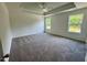 Spacious bedroom features a trey ceiling, neutral carpet, and two windows offering great natural light at 235 Grand Griffon Way, Lillington, NC 27546