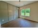 Dining area features hardwood floors, stylish chandelier, and a large window overlooking the lawn at 235 Grand Griffon Way, Lillington, NC 27546