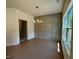 Dining room with hardwood floors, stylish chandelier, and a decorative panel wall design at 235 Grand Griffon Way, Lillington, NC 27546