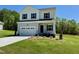 Charming two-story home with a two-car garage, verdant lawn, and inviting front exterior at 235 Grand Griffon Way, Lillington, NC 27546