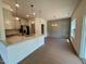 Open concept kitchen with granite countertops, stainless appliances, and a view into the dining room at 235 Grand Griffon Way, Lillington, NC 27546