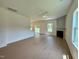 Spacious living room with hardwood floors, a ceiling fan, and a stylish fireplace at 235 Grand Griffon Way, Lillington, NC 27546