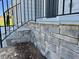Close up of the stonework surrounding the front porch, highlighting the detail and craftsmanship at 235 Grand Griffon Way, Lillington, NC 27546