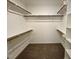Walk-in closet featuring ample shelving and rods for optimal organization at 235 Grand Griffon Way, Lillington, NC 27546
