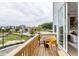 Relaxing outdoor balcony with a wooden deck, yellow chair, and views of the community at 1170 Holding Village Way, Wake Forest, NC 27587