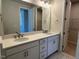Modern bathroom featuring double sinks, granite countertop, and a large mirror at 1170 Holding Village Way, Wake Forest, NC 27587