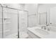 Modern bathroom features a walk-in shower with sliding glass doors and a single sink vanity at 1170 Holding Village Way, Wake Forest, NC 27587