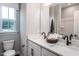 Bright bathroom features a double vanity, modern fixtures, and a serene view from the window at 1170 Holding Village Way, Wake Forest, NC 27587