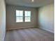 Bedroom featuring plush carpeting, two windows and neutral paint at 1170 Holding Village Way, Wake Forest, NC 27587