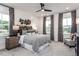 This primary bedroom offers natural light, a ceiling fan and a gorgeous accent wall at 1170 Holding Village Way, Wake Forest, NC 27587