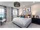 Cozy bedroom with soft carpet, a chandelier, a queen-sized bed, and patterned curtains at 1170 Holding Village Way, Wake Forest, NC 27587