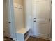 Mudroom featuring a bench with hooks, white doors, and wood look flooring at 1170 Holding Village Way, Wake Forest, NC 27587