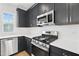 Close up of the kitchen's stainless steel dishwasher, range, and microwave at 1170 Holding Village Way, Wake Forest, NC 27587
