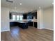 Spacious kitchen with island featuring dark cabinets, hardwood floors and stainless steel appliances at 1170 Holding Village Way, Wake Forest, NC 27587