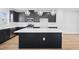 This kitchen has dark cabinets, stainless appliances, and a white countertop island at 1170 Holding Village Way, Wake Forest, NC 27587