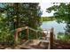 View of the wooden steps leading down to the pond, a peaceful escape into nature at 1170 Holding Village Way, Wake Forest, NC 27587