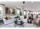 Open-concept living room with hardwood floors, modern décor, and an abundance of natural light at 1170 Holding Village Way, Wake Forest, NC 27587