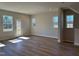 Bright living room featuring wood-look flooring, windows and a glass door to the outside at 1170 Holding Village Way, Wake Forest, NC 27587