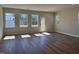 Sun-filled living room with windows, a glass door, and wood-look flooring at 1170 Holding Village Way, Wake Forest, NC 27587