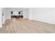 Expansive open-concept space with wood-style floors leading to the kitchen area at 1170 Holding Village Way, Wake Forest, NC 27587
