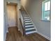 Entryway featuring wood staircase, wood-look floors, and a conveniently placed window for natural light at 1170 Holding Village Way, Wake Forest, NC 27587
