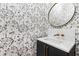 Powder room with marble vanity and floral wallpaper at 1610 Carson St, Raleigh, NC 27608