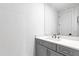 Modern bathroom with grey vanity and white quartz countertop at 1610 Carson St, Raleigh, NC 27608