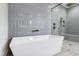 Bathroom with soaking tub and walk-in shower, both with gray tile at 1610 Carson St, Raleigh, NC 27608