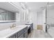 Modern bathroom featuring a double vanity and a walk-in shower at 1610 Carson St, Raleigh, NC 27608