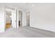 Spacious bedroom with grey carpet and access to a full bathroom at 1610 Carson St, Raleigh, NC 27608
