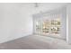 Bright bedroom with grey carpet and large windows offering ample natural light at 1610 Carson St, Raleigh, NC 27608