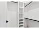 White built-in shelving and hanging rods offer ample closet storage at 1610 Carson St, Raleigh, NC 27608