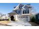 Gray two-story house with stone accents, a two-car garage, and a paved driveway at 1610 Carson St, Raleigh, NC 27608