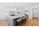 Contemporary kitchen with white cabinets, stainless steel appliances, and an island with seating at 1610 Carson St, Raleigh, NC 27608
