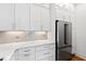 Stainless steel refrigerator in white kitchen with quartz countertops at 1610 Carson St, Raleigh, NC 27608