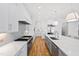 Modern kitchen featuring white cabinets, stainless steel appliances, and a large island at 1610 Carson St, Raleigh, NC 27608