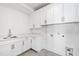 Laundry room with white cabinets and hexagon tile floor at 1610 Carson St, Raleigh, NC 27608