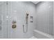 Spa-like shower with gray tile, built-in seat and rainfall shower head at 1610 Carson St, Raleigh, NC 27608