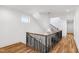 Open staircase with wood flooring and a contemporary chandelier at 1610 Carson St, Raleigh, NC 27608