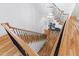 Elegant staircase with wood railings and a modern light fixture at 1610 Carson St, Raleigh, NC 27608