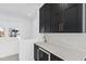 Modern wet bar with dark cabinetry, quartz countertops and wine cooler at 1610 Carson St, Raleigh, NC 27608