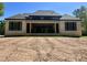 Spacious backyard view with modern brick home and covered patio at 65 Firefly Overlook, Pittsboro, NC 27312